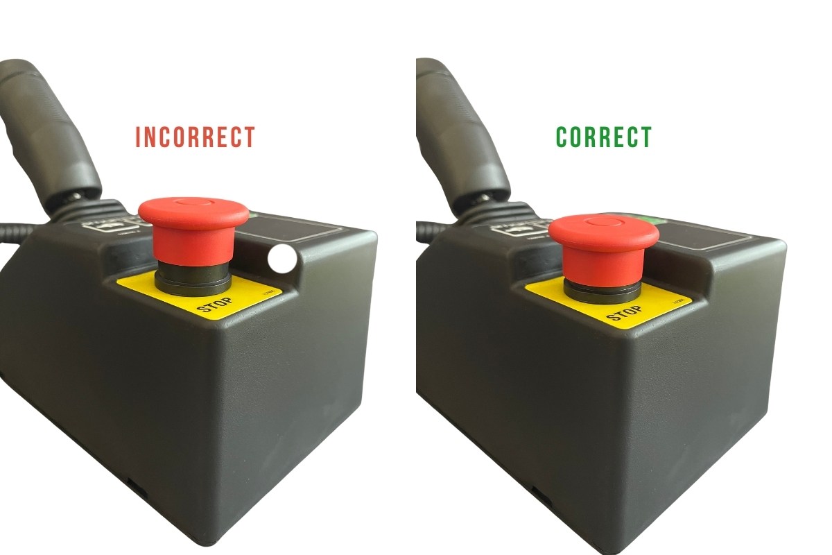 Scissor lift control console zoomed on the e-stop button